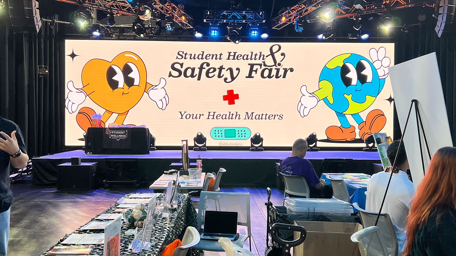 Screen in Full Sail’s The Fortress depicting an animation of a heart and an earth that reads “Student Health and Safety Fair” and “Your Health Matters.”