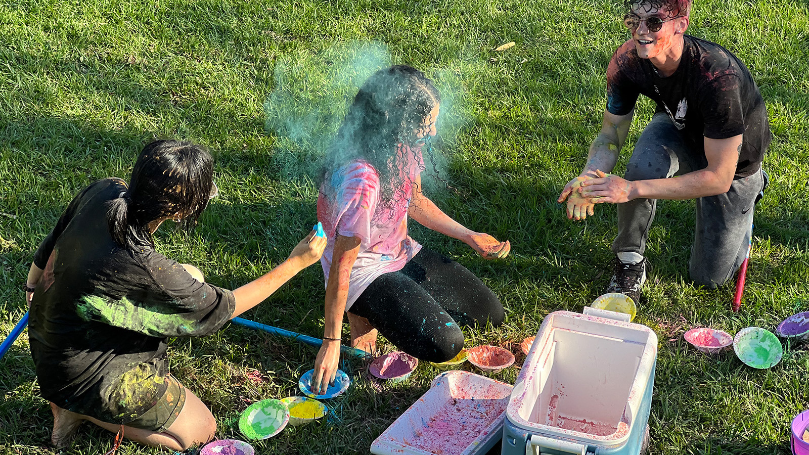 Students throw colored powder at the Holi Festival of Colors.