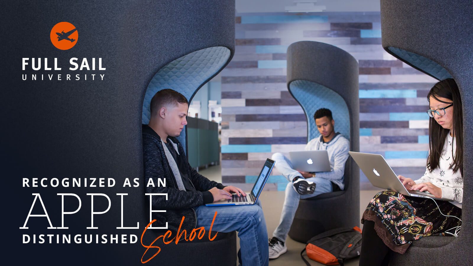 Three students using MacBooks sit on gray and blue chairs. The Full Sail logo is in the image’s top-left corner with the words “Recognized as an Apple Distinguished School” beneath it
