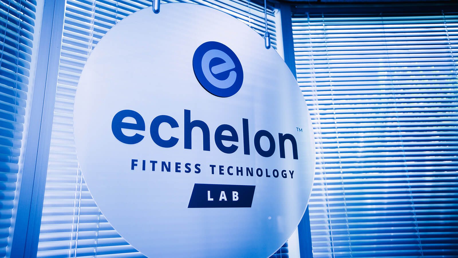 A photograph of a sign on door that reads "Echelon Fitness Technology Lab".