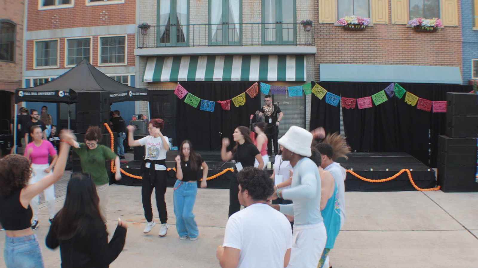 A group dancing at the Latin Music Festival hosted at the Full Sail Backlot.