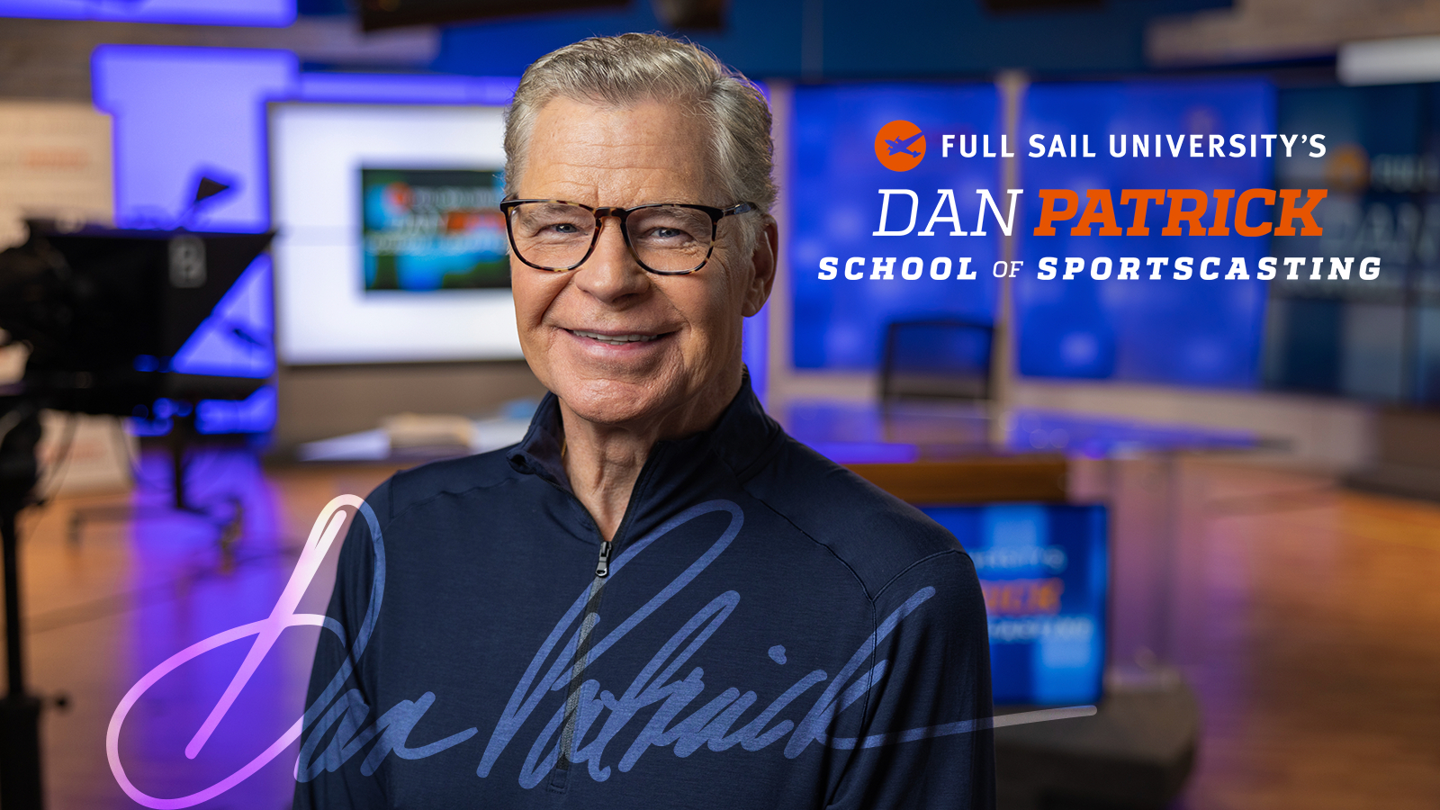 Dan Patrick stands in front of a broadcast desk and smiles at the camera. The words Full Sail University’s Dan Patrick School of Sportscasting are on the right.