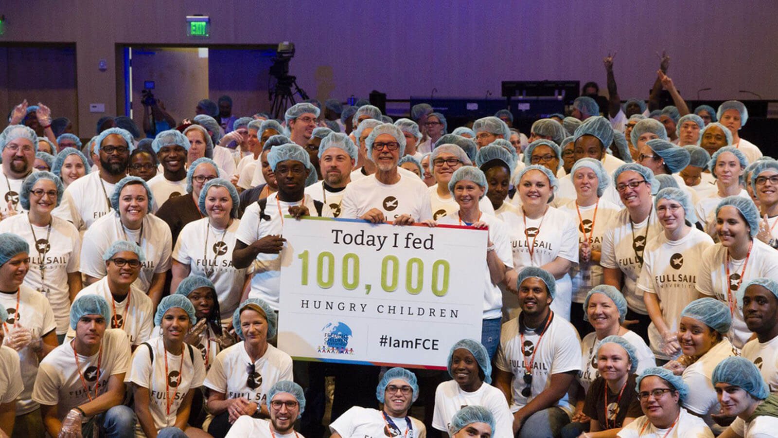 Pure Motivation Joins Local Charity to Package 100,000 Meals for Hungry Families - Hero image