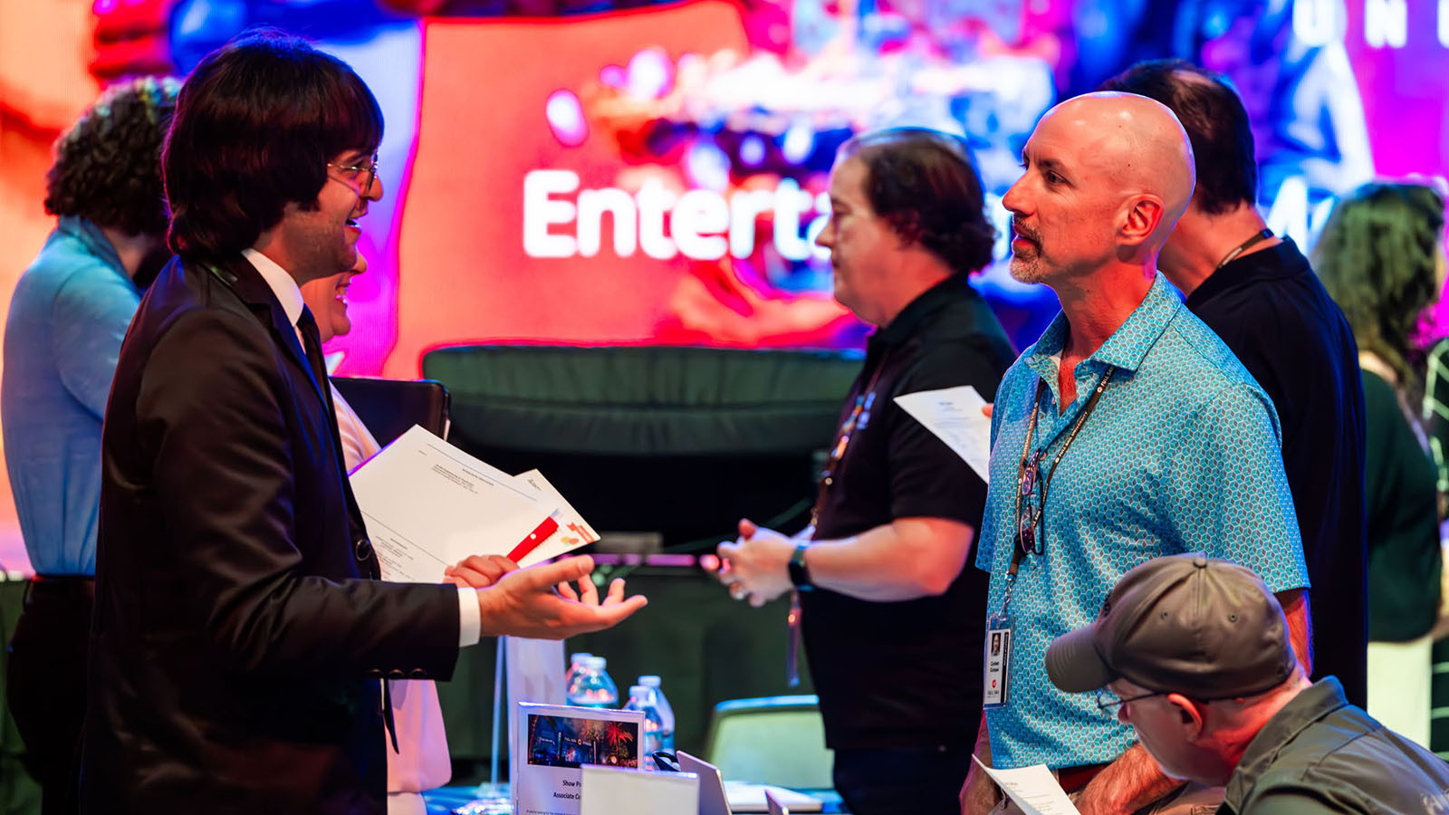 Students network with employers at the career fair in the Full Sail Live venue.