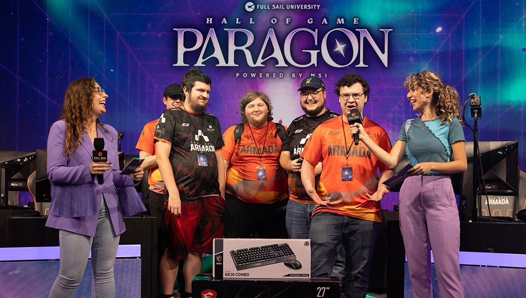 A group of players in various Full Sail Armada team jerseys on stage in the Fortress with hosts, the screen behind them reads “Hall of Game Paragon Powered by MSI.”