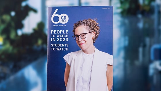 The February 2023 print edition of ‘Graphic Design USA.’ The cover features a smiling designer and text saying “People to Watch in 2023: Students to Watch.”