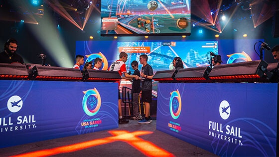 Two Special Olympians shaking hands after a match on stage at the Full Sail University Orlando Health Fortress.