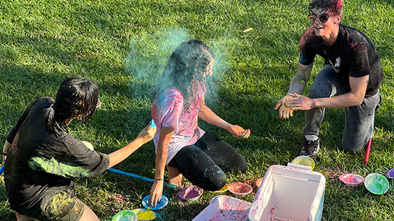 Students throw colored powder at the Holi Festival of Colors.