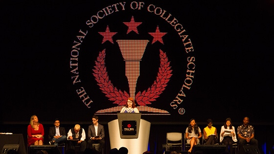 Full Sail’s National Society of Collegiate Scholars chapter members on stage at an NSCS ceremony.