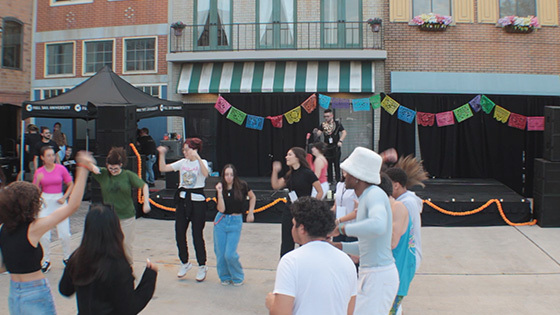 A group dancing at the Latin Music Festival hosted at the Full Sail Backlot.