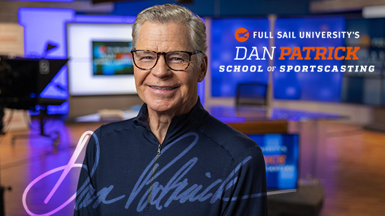 Dan Patrick stands in front of a broadcast desk and smiles at the camera. The words Full Sail University’s Dan Patrick School of Sportscasting are on the right.