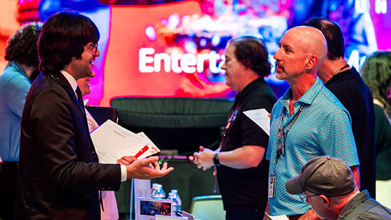 Students network with employers at the career fair in the Full Sail Live venue.