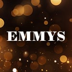 The word 'EMMYS' appears in block white text over a dark, blurred scene filled with warm, glowing lights in shades of gold, orange, and brown.