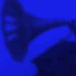 A graphic of a gramophone on a blue background. The words 2023 Latin Grammys are overlaid in white.