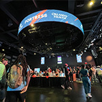 Fish-eye view of the Student Resource Fair. Several lines of booths are set up and many students are walking around the venue.