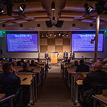 An audience watches a group of panelists give a presentation on stage at Central Florida's Second Annual Immersive Technology Summit.