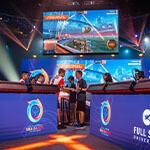 Two Special Olympians shaking hands after a match on stage at the Full Sail University Orlando Health Fortress.