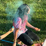 Students throw colored powder at the Holi Festival of Colors.