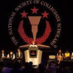 Full Sail’s National Society of Collegiate Scholars chapter members on stage at an NSCS ceremony.