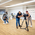 Students explore Full Sail’s Spatial Computing Innovation Lab with Apple Vision Pro, iMacs, and immersive camera technology.