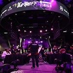 The Full Sail University Orlando Health Fortress esports arena’s main stage and large screens feature Jump Off’s purple and white branding while competitors face-off at gaming stations.