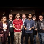 The recipients of the Made with Unity recognition award stand with their statuettes with Full Sail and Advent Health University course and education directors.