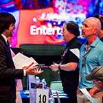 Students network with employers at the career fair in the Full Sail Live venue.