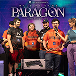 A group of players in various Full Sail Armada team jerseys on stage in the Fortress with hosts, the screen behind them reads “Hall of Game Paragon Powered by MSI.”