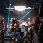 A camera crew films WWE Superstar Big E under bright stage lights for Netflix's RAW Classics at Full Sail University.