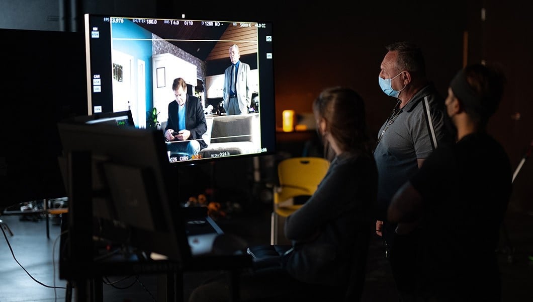 Crew members work in front of a computer displaying the Unreal Engine view of the '9 Windows' set.