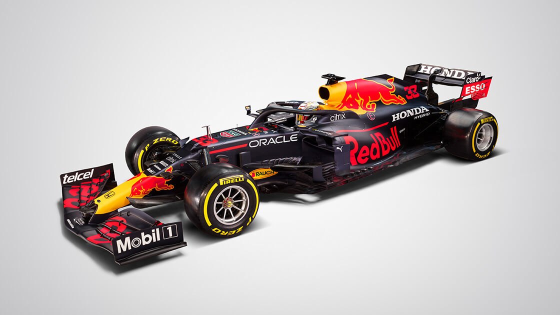 A black Formula One race car featuring yellow and red accents along with the Red Bull logo.