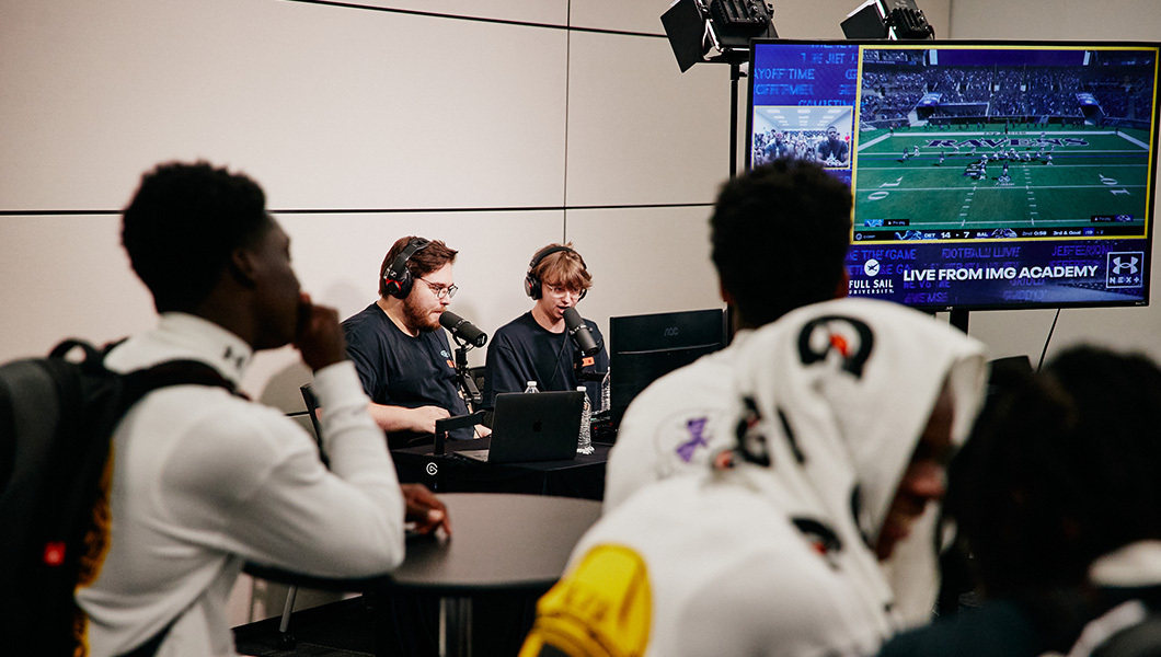 Casters call a ‘Madden’ match live from IMG Academy as players watch the action unfold on a big screen.
