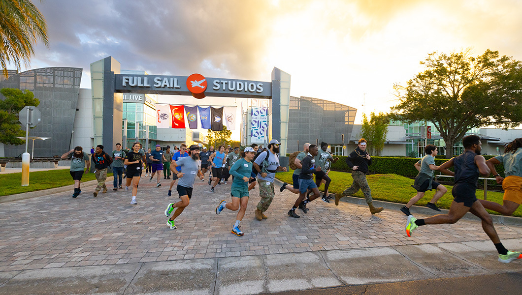 Dozens of runners race under the Full Sail Studios sign and into the parking lot.