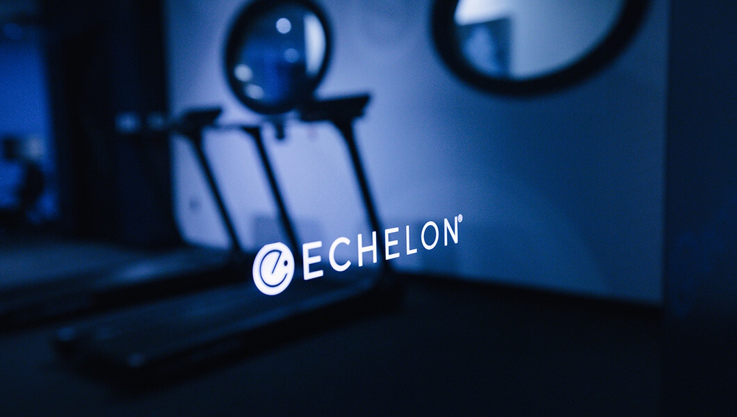Echelon’s logo on the lab’s Echelon Connect Reflect mirror featuring a reflection of the campus lab.