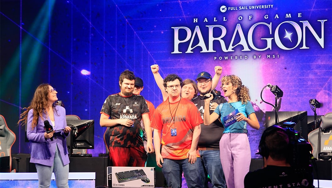 A group of players in various Full Sail Armada team jerseys on stage in the Fortress with hosts, the screen behind them reads “Hall of Game Paragon Powered by MSI.”